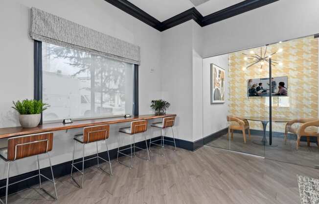 a seating area in a room with a large window and wooden floors