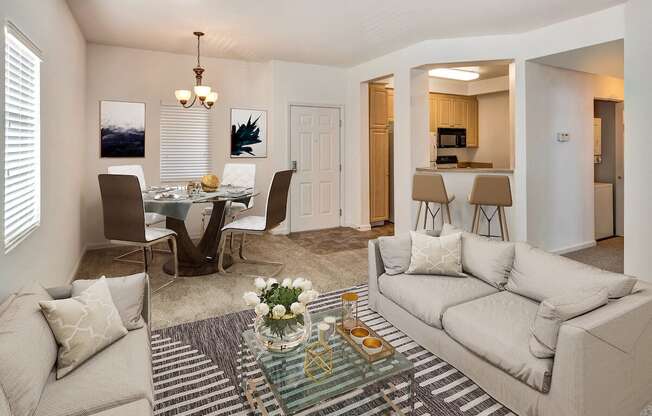 a living room with a couch and a table with chairs  at Falcon Bridge at Gale Ranch, California, 94582