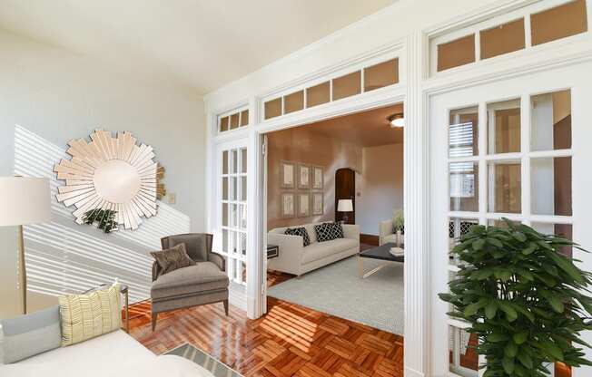 living area with sofa, coffee table, hardwood floors and view of sunroom at eddystone apartments in washington dc