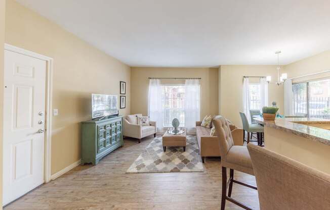 A living room with a green cabinet and a rug on the floor.