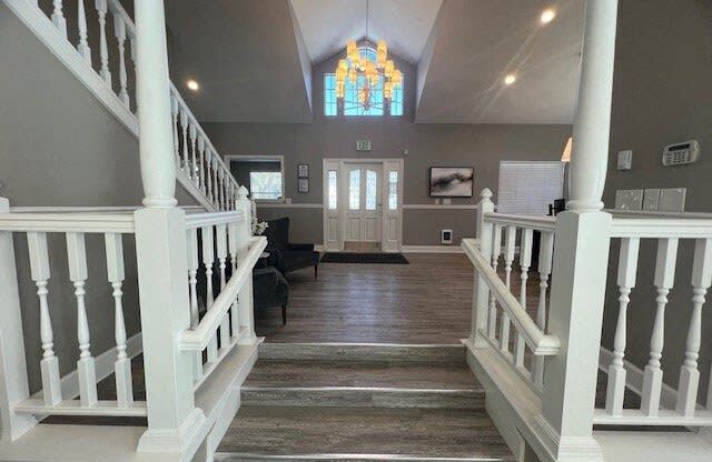 a large hallway with stairs and a church door