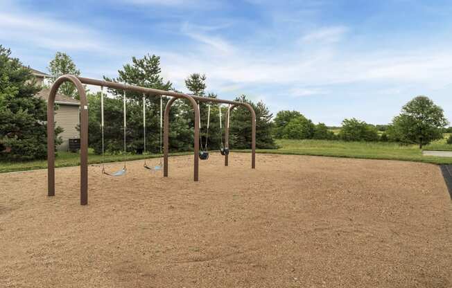 Swings at Schleich Park near Cascade Pines Duplex and Townhomes
