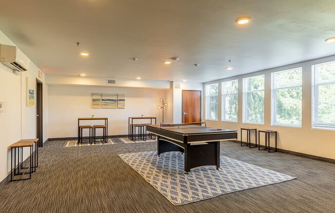 134th street lofts resident lounge and game room with a ping pong table and chairs