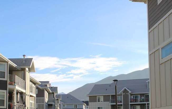 a view of the balconies of a building from the roof of another building