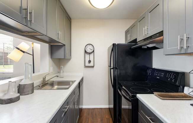 a kitchen with black appliances and white counter tops