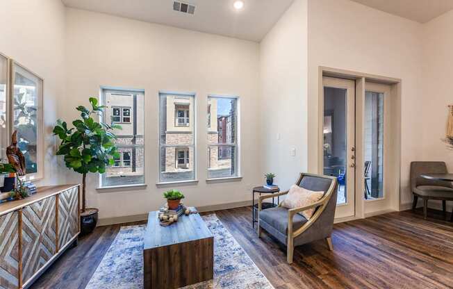 A living room with a brown wooden floor and a grey sofa.