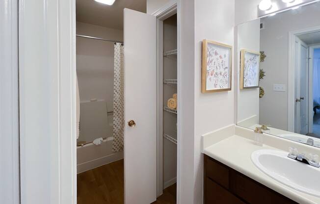 a bathroom with a sink and mirror in a 555 waverly unit