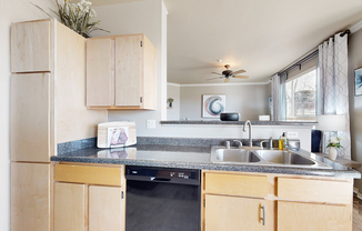 Experience the seamless flow from kitchen to living space in this modern apartment.