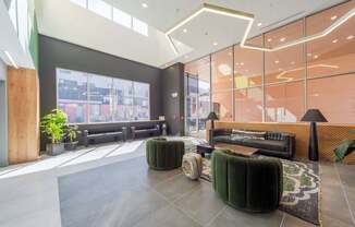 A modern waiting area with a large window and comfortable seating.