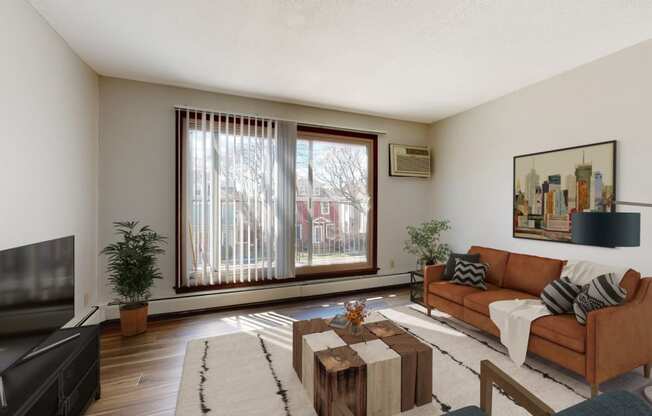 a living room with a couch and a coffee table in front of a large window