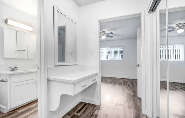 a white bathroom with a sink and a mirror