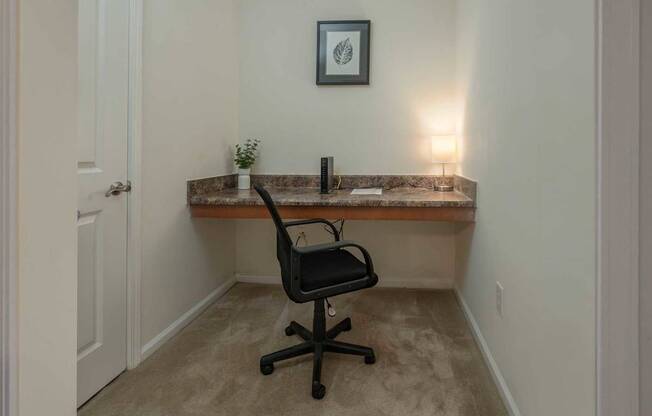 A small room with a desk and a chair.