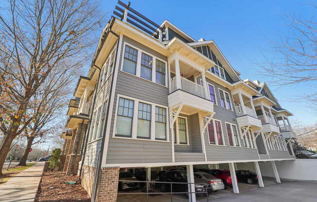 A modern two-story house with a balcony on the second floor.