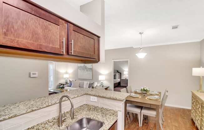 a kitchen with a sink and a dining table