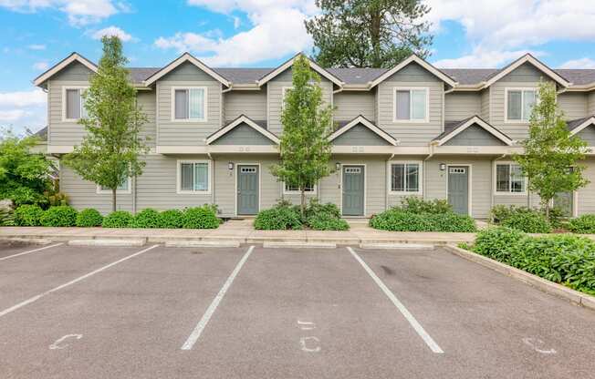 an empty parking lot in front of a house