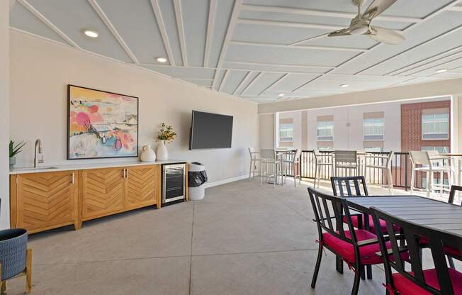 A room with a ceiling fan and a painting on the wall.