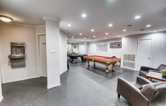 a game room with a pool table and a billiard table