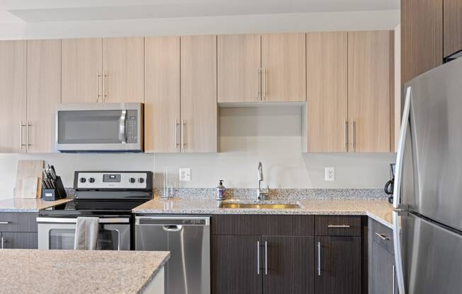 a kitchen with wooden cabinets and granite countertops