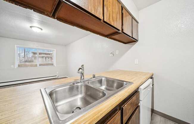 A kitchen with a sink and a dishwasher.