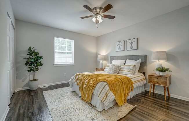 a bedroom with a bed and a ceiling fan