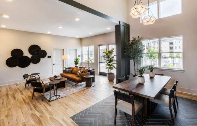 a living room and dining room with a table and chairs