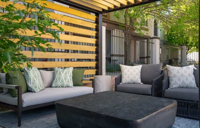 a patio with couches and a coffee table