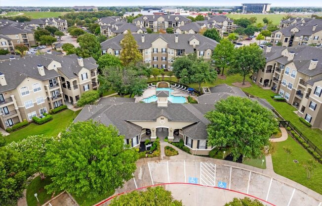 an aerial view of a large house with a swimming pool in the middle of it