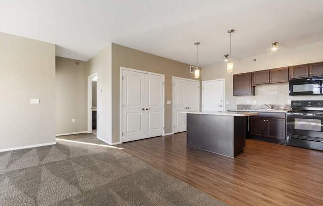 A kitchen with a black counter top and white cabinets.