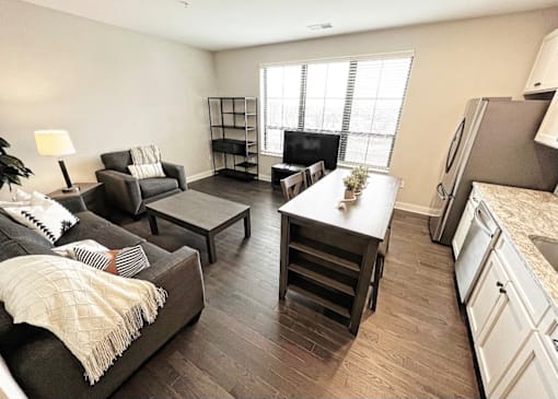 a living room with a couch a table and a television at Fairfax, Grandview, OH