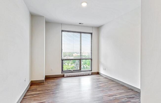 Spacious bedroom with floor-to-ceiling windows a 2 bedroom penthouse floor plan Midtown Crossing Apartments Omaha