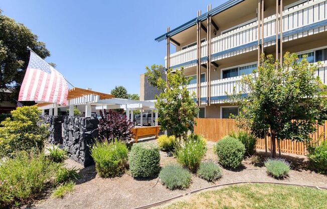 an american flag flies in front of a building