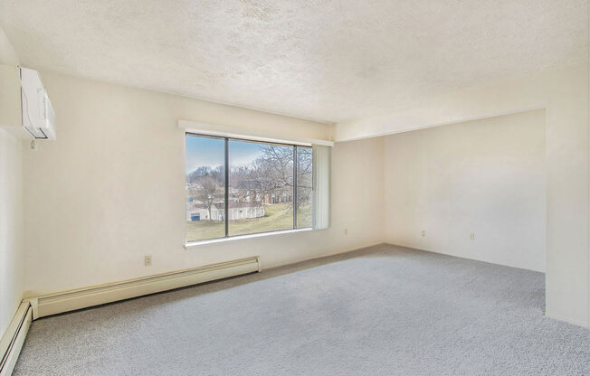 an empty living room with a large window