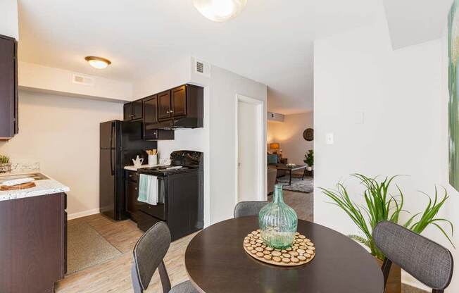 a kitchen and dining room with a table and chairs