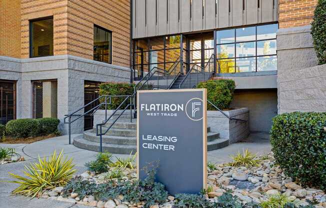 Flatiron West Trade Apartments picture of sign reading "Leasing Center" in front of covered walkway
