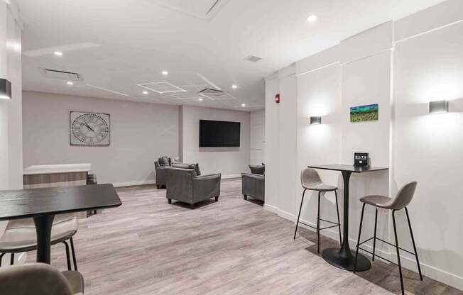 a living room with a table and chairs and a tv