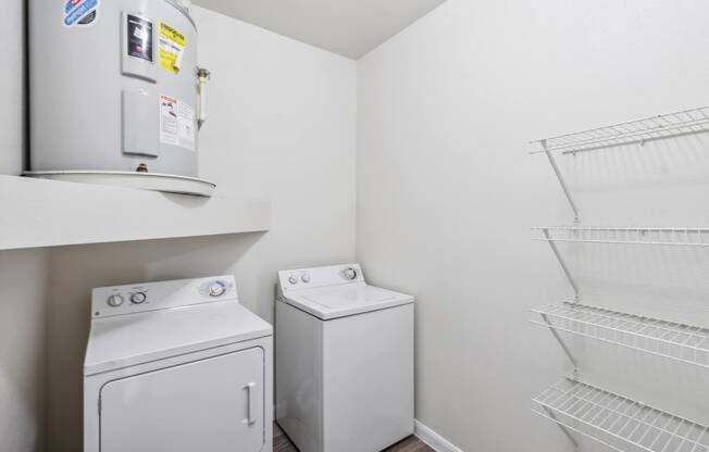 a white laundry room with a washer and dryer and a refrigerator at St. Augustine Estate, Dallas, Texas