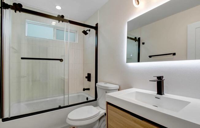 a bathroom with a toilet sink and a shower