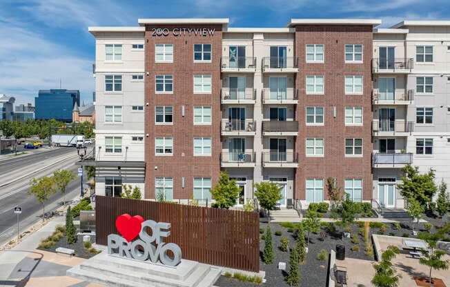 a large sign in front of a building with a red heart on it
