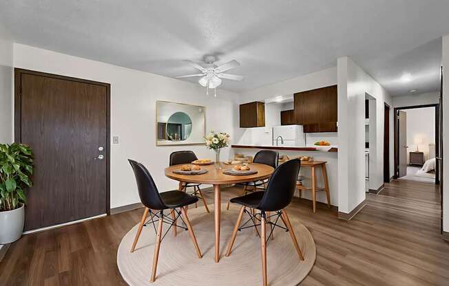 A modern dining room with a round table and chairs.