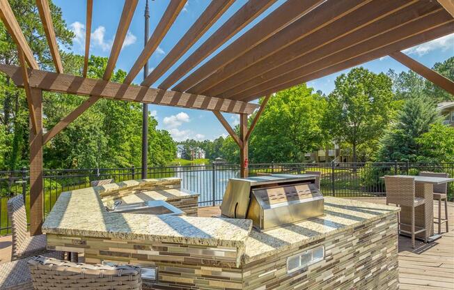 a patio with a grill and a table and chairs