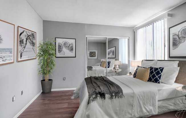 a bedroom with a large bed and a large mirror