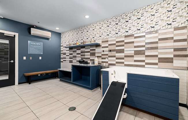 A room with a blue bench and a wall with a checkered pattern.