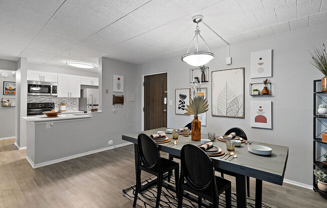 A dining room with a table set for four.