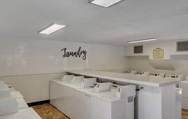 Laundry room with washers and dryers.