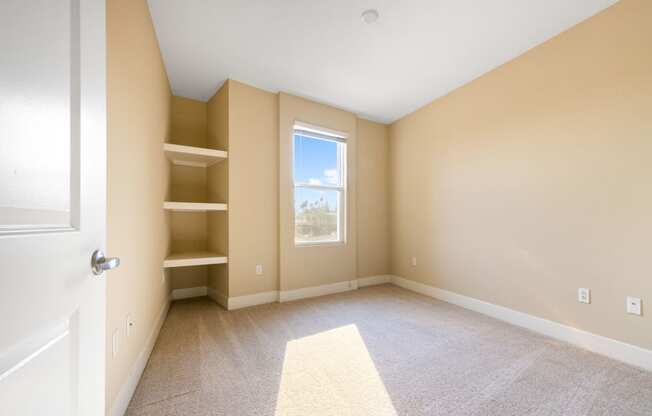 a bedroom with beige walls and a window