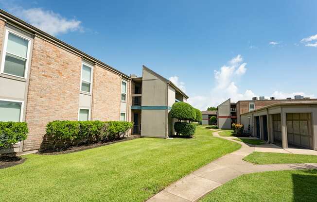 A sunny day at a residential area with apartment buildings and green lawns.