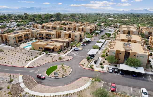 an aerial view of a housing complex with a roundabout in the middle of the road