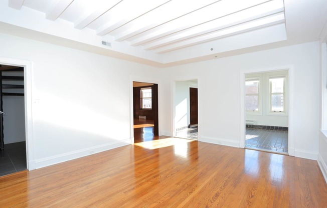 Penthouse living room with wood floorig and white walls at York House, Saint Louis, Missouri