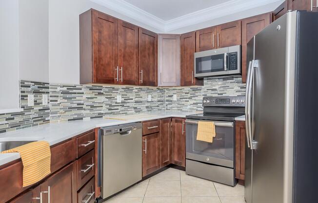 a kitchen with stainless steel appliances and wooden cabinets