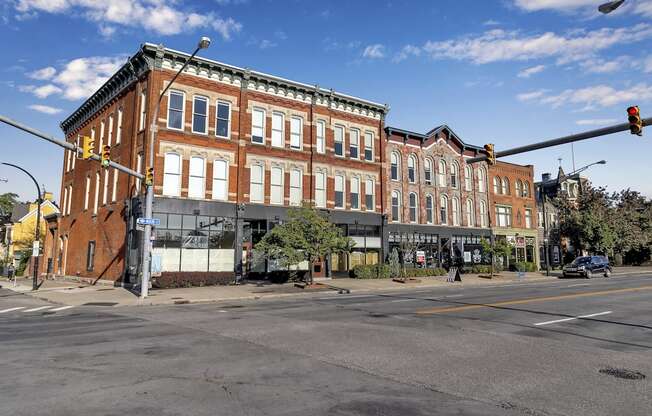 a large brick building on the corner of a city street